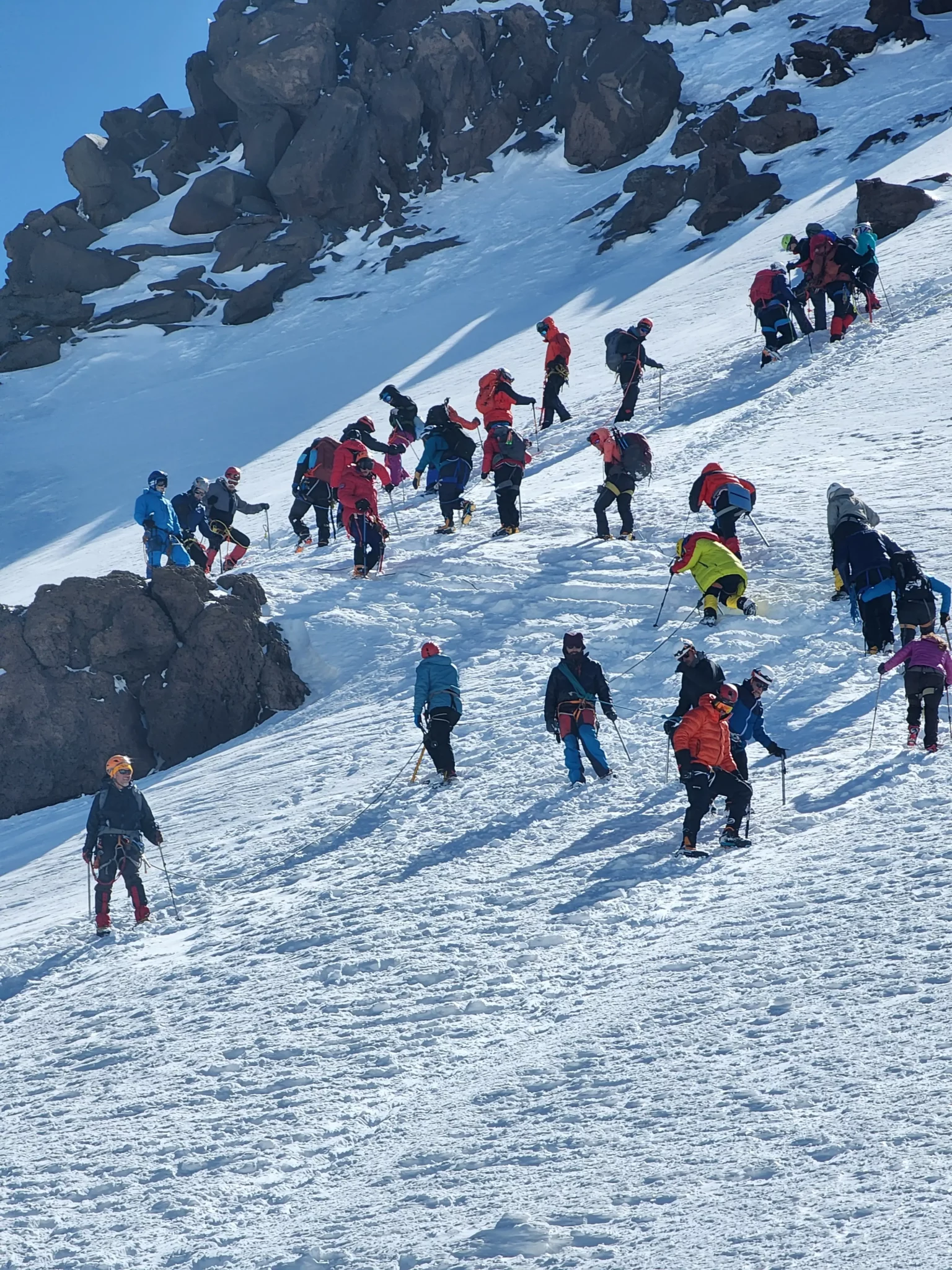 Climbers ascending the final snow slope on Mount Kazbek summit push
