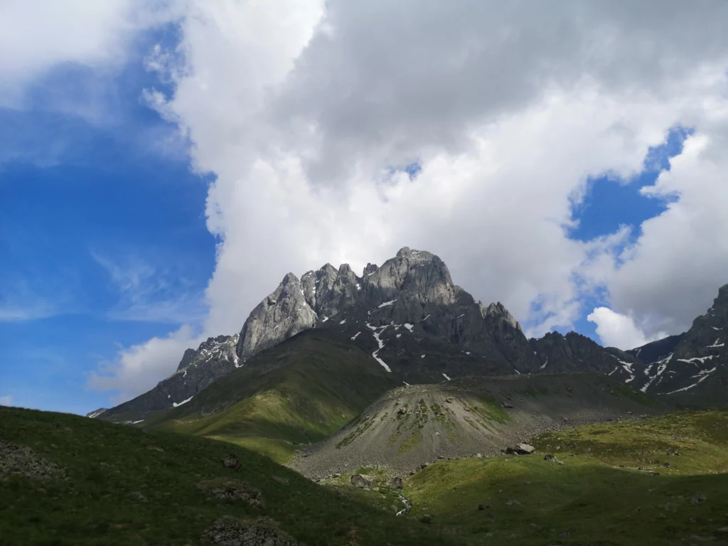 Rocky Chaukhi mountains from base camp in cloudy weather
