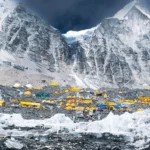 Everest Base Camp packed with colorful expedition tents beneath towering Himalayan peaks