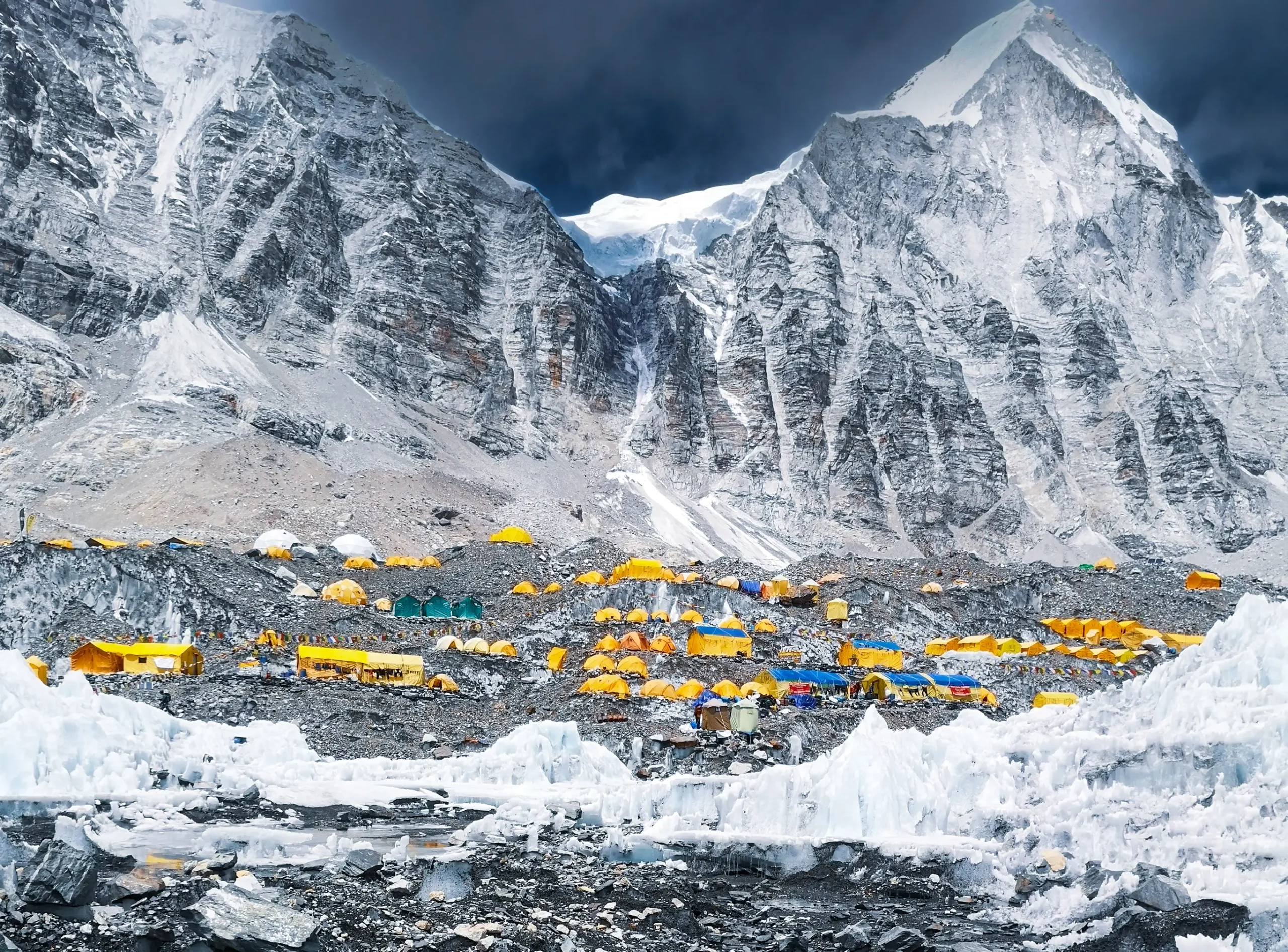 Everest Base Camp packed with colorful expedition tents beneath towering Himalayan peaks