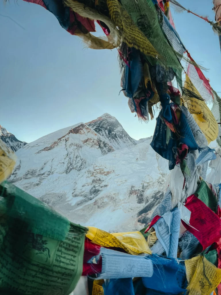 Majestic Mount Everest through Vibrant Prayer Flags
