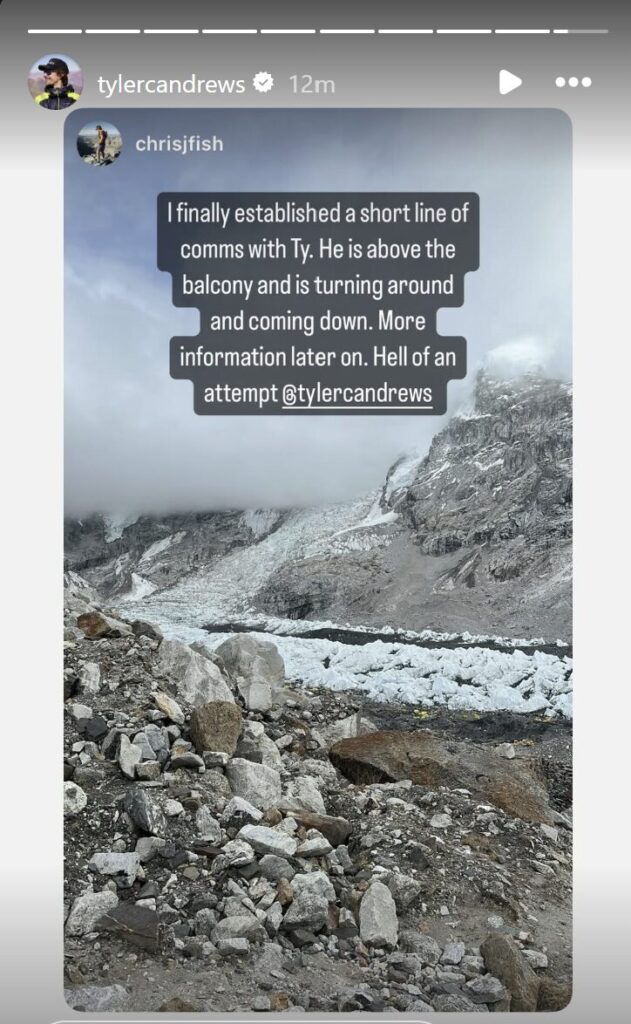An Instagram story post by @tylercandrews shares an update from @chrisjfish, overlaid on a photo of a rocky, glaciated mountain slope under cloudy skies. The message reads: “I finally established a short line of comms with Ty. He is above the balcony and is turning around and coming down. More information later on. Hell of an attempt @tylercandrews.” The scene reflects the harsh and dramatic environment of high-altitude mountaineering.