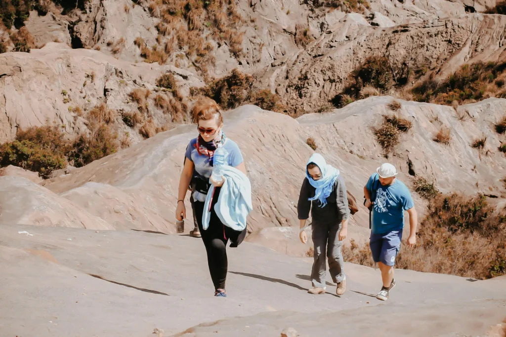 three person hiking on mountains