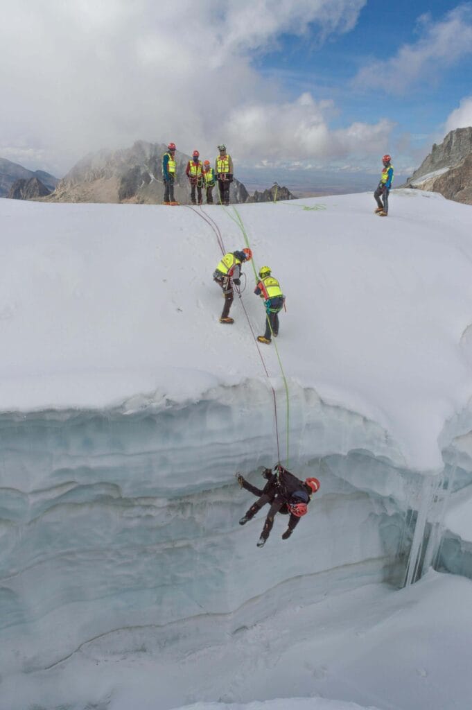 Men in Visibility Vests Pulling a Rope
