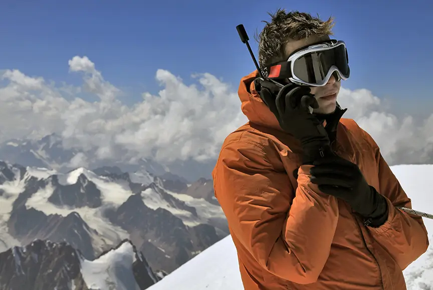 man with satellite phone on mountain