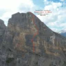 A rugged mountain cliff in the Dolomiti di Fanes, Furcia Rossa III, with an orange dashed line marking a climbing route labeled "il tempo sospeso - IX / 300 mt." The route is credited to Leo Gheza and Luca Ducoli, dated August 2025, under clear skies with some clouds.